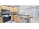 Eat-in kitchen with stainless steel appliances and light wood cabinets at 940 Village Trl # 8-101, Port Orange, FL 32127