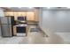 Modern kitchen with stainless steel appliances and light wood cabinets at 940 Village Trl # 8-101, Port Orange, FL 32127