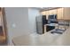 Updated kitchen featuring stainless steel appliances and light cabinetry at 940 Village Trl # 8-101, Port Orange, FL 32127