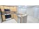 Updated kitchen featuring stainless steel appliances and light wood cabinetry at 940 Village Trl # 8-101, Port Orange, FL 32127