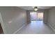 Spacious living room with tile floors and sliding glass doors at 940 Village Trl # 8-101, Port Orange, FL 32127