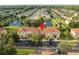Aerial view showing townhome community near a lake at 1065 Park Ridge Cir, Kissimmee, FL 34746