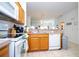 Kitchen with wood cabinets, appliances, and view of dining area at 1065 Park Ridge Cir, Kissimmee, FL 34746