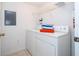 Bright laundry room with washer, dryer, and shelving at 1065 Park Ridge Cir, Kissimmee, FL 34746