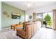 Bright living room with comfy seating, large TV, and sliding glass doors leading to the backyard at 1065 Park Ridge Cir, Kissimmee, FL 34746