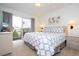 Spacious main bedroom with a king-size bed and private balcony overlooking the lake at 1065 Park Ridge Cir, Kissimmee, FL 34746