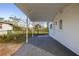 Covered back patio with concrete flooring and backyard access at 128 Academy Ave, Sanford, FL 32771