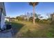 Backyard view of house with AC unit and grass at 128 Academy Ave, Sanford, FL 32771