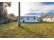 View of house from backyard, grass, palm tree at 128 Academy Ave, Sanford, FL 32771