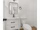 Clean bathroom with white vanity, black hardware, and toilet at 128 Academy Ave, Sanford, FL 32771