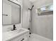 Updated bathroom with white vanity, tub, and black accents at 128 Academy Ave, Sanford, FL 32771