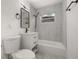 Modern bathroom with white vanity, bathtub, and black fixtures at 128 Academy Ave, Sanford, FL 32771