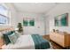 Light and airy bedroom with wood floors, dresser, and bed at 128 Academy Ave, Sanford, FL 32771