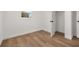 Empty bedroom with wood-look floors and neutral walls at 128 Academy Ave, Sanford, FL 32771