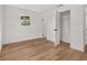 Bright bedroom with wood-look floors and two closets at 128 Academy Ave, Sanford, FL 32771