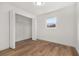 Bright bedroom with spacious closet and wood-look floors at 128 Academy Ave, Sanford, FL 32771