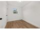 Simple bedroom with wood-look floors and neutral walls at 128 Academy Ave, Sanford, FL 32771