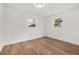 Simple bedroom with wood-look floors and neutral decor at 128 Academy Ave, Sanford, FL 32771