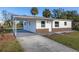 Newly renovated house with a carport and a spacious front yard at 128 Academy Ave, Sanford, FL 32771