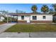 Newly renovated house featuring a carport and well-maintained lawn at 128 Academy Ave, Sanford, FL 32771