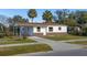 Newly renovated house with a carport and a well-maintained lawn at 128 Academy Ave, Sanford, FL 32771