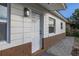 Newly renovated front door with modern fixtures and brick detailing at 128 Academy Ave, Sanford, FL 32771
