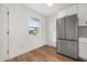 Modern kitchen with stainless steel appliances and white cabinets at 128 Academy Ave, Sanford, FL 32771