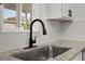 Modern kitchen sink with black faucet and granite countertop at 128 Academy Ave, Sanford, FL 32771