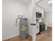 Laundry room with water heater and kitchen view at 128 Academy Ave, Sanford, FL 32771