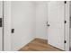 Laundry room with wood floors and white door at 128 Academy Ave, Sanford, FL 32771