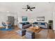 Open concept living room with hardwood floors and modern decor at 128 Academy Ave, Sanford, FL 32771