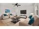 Living room with hardwood floors, modern furniture, and large TV at 128 Academy Ave, Sanford, FL 32771