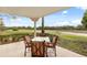 Enjoy a relaxing view of the golf course from this patio, complete with a table and chairs at 1354 Centre Court Ridge Dr # 101, Reunion, FL 34747