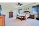 Large main bedroom with ample space, carpeted floors, and ceiling fan at 15886 Citrus Grove Loop, Winter Garden, FL 34787