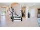 Modern staircase with black and white railings at 15886 Citrus Grove Loop, Winter Garden, FL 34787