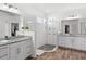 Modern bathroom with double vanity, walk-in shower, and granite countertops at 16719 Sanctuary Dr, Winter Garden, FL 34787