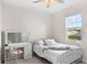 Bedroom with bed, vanity, and window overlooking backyard at 16719 Sanctuary Dr, Winter Garden, FL 34787