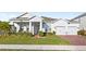 Gray house with a two-car garage and manicured lawn at 16719 Sanctuary Dr, Winter Garden, FL 34787