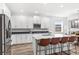 Modern kitchen with white cabinets, stainless steel appliances, and an island at 16719 Sanctuary Dr, Winter Garden, FL 34787