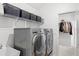 Laundry room with washer, dryer, and storage shelves at 16719 Sanctuary Dr, Winter Garden, FL 34787