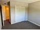 Bedroom with mirrored closet doors and access to bathroom at 1695 Lee Rd # B211, Winter Park, FL 32789