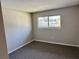 Bright bedroom with a window offering an outdoor view at 1695 Lee Rd # B211, Winter Park, FL 32789