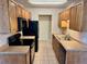 Kitchen with wood cabinets and a double sink at 1695 Lee Rd # B211, Winter Park, FL 32789