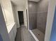 Modern bathroom featuring a tiled shower, with a doorway leading to a closet at 1696 Andover Ridge Dr, Deland, FL 32720