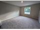 Clean, carpeted bedroom with a bright window at 1696 Andover Ridge Dr, Deland, FL 32720