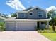 Charming two-story home with a three-car garage and brick driveway, perfect for a growing Gathering at 1696 Andover Ridge Dr, Deland, FL 32720