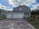 Two story home with a brick paver driveway and three car garage at 1696 Andover Ridge Dr, Deland, FL 32720