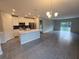 Open-concept kitchen featuring white cabinets, stainless steel appliances, and an island at 1696 Andover Ridge Dr, Deland, FL 32720