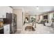 Modern kitchen with granite countertops, stainless steel appliances, and an open view to the living room at 1696 Andover Ridge Dr, Deland, FL 32720