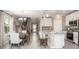 Open concept kitchen and dining area with white cabinets and gray flooring at 1696 Andover Ridge Dr, Deland, FL 32720